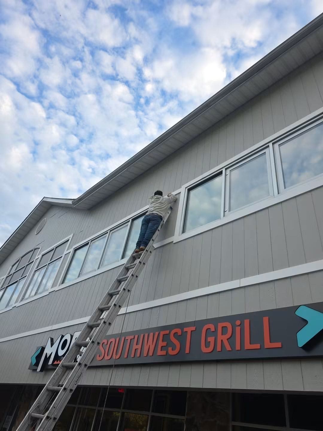 Exterior prep and painting on a commercial retail storefront
